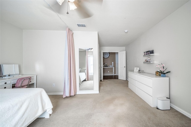 bedroom featuring visible vents, light carpet, baseboards, and ceiling fan