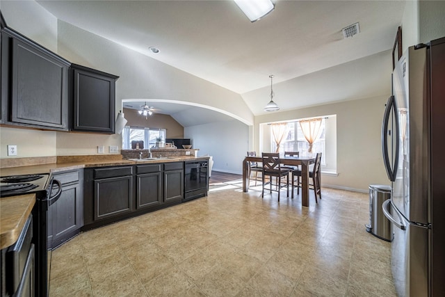 kitchen with arched walkways, a sink, ceiling fan, black appliances, and vaulted ceiling