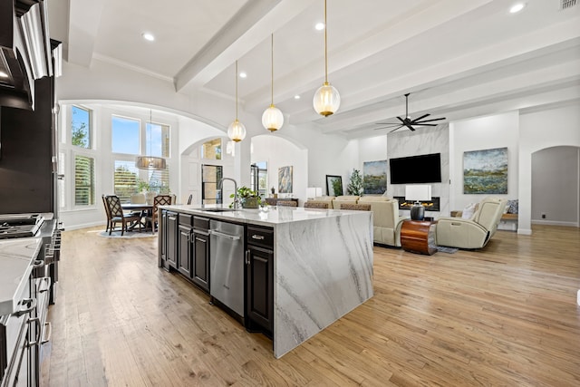 504 Shadow Wood Ln, Heath, TX 75032 - kitchen with arched walkways, stainless steel dishwasher, a ceiling fan, a sink, and beam ceiling