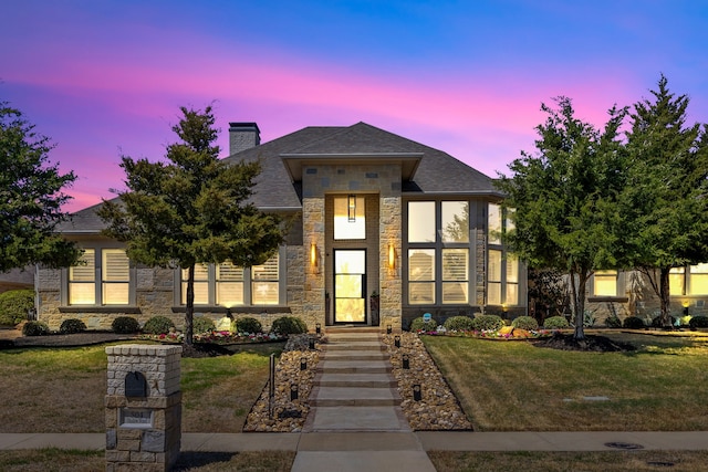 504 Shadow Wood Ln, Heath, TX 75032 - view of front of house with stone siding, a chimney, a lawn, and a shingled roof