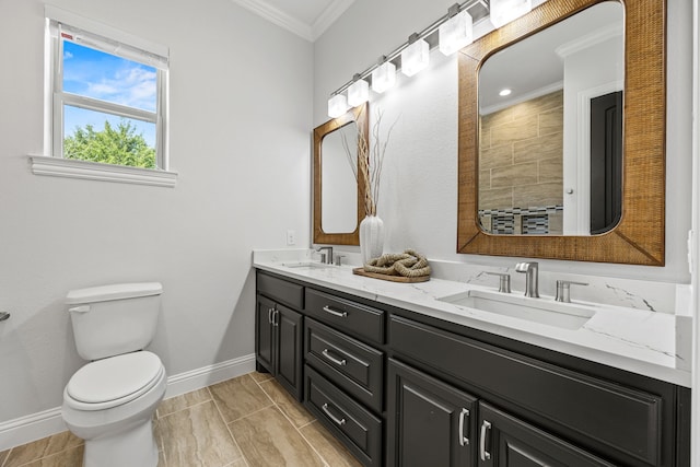 504 Shadow Wood Ln, Heath, TX 75032 - bathroom featuring crown molding, double vanity, toilet, and baseboards