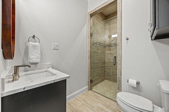 504 Shadow Wood Ln, Heath, TX 75032 - bathroom with toilet, vanity, a stall shower, and baseboards