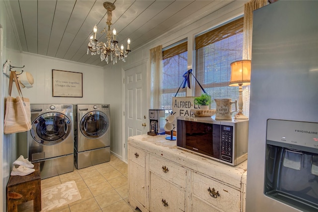 laundry room with light tile patterned flooring, a notable chandelier, wood ceiling, laundry area, and washer and dryer