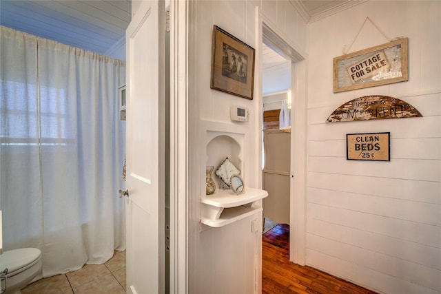 bathroom with toilet, tile patterned flooring, and ornamental molding