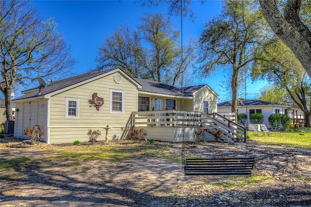 rear view of property featuring stairs, central air condition unit, and a deck