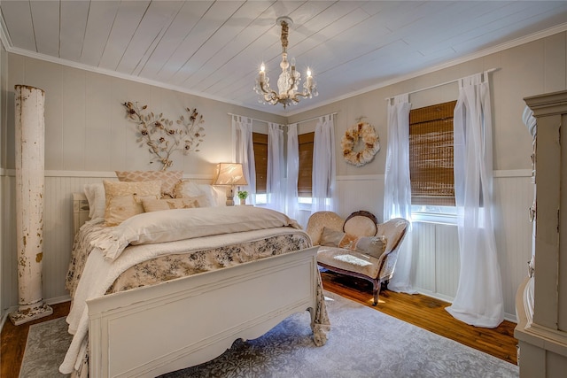 bedroom featuring wood ceiling, crown molding, wood finished floors, and a notable chandelier