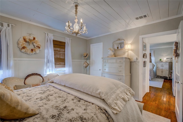 bedroom with visible vents, crown molding, a notable chandelier, wooden ceiling, and wood-type flooring