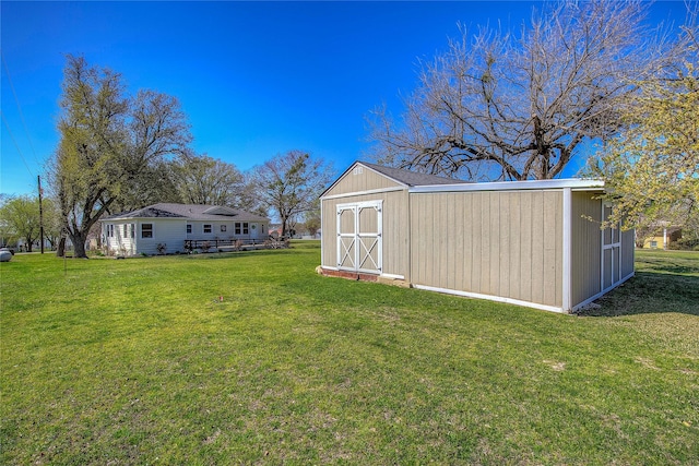 view of yard featuring an outbuilding and a storage unit