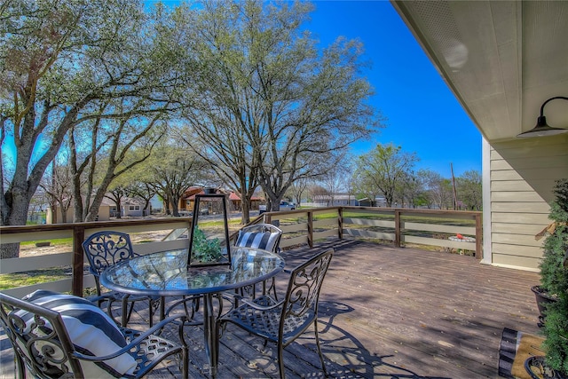 wooden terrace featuring outdoor dining area