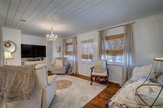 living area featuring wood ceiling, visible vents, a chandelier, and wood finished floors