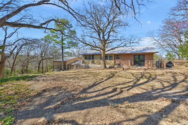 view of front facade with board and batten siding and metal roof