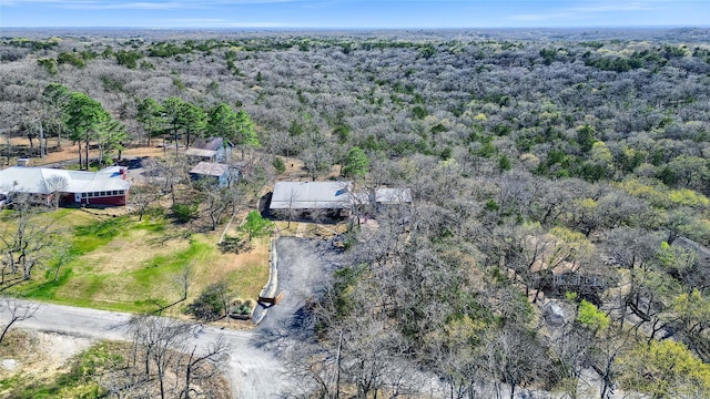 birds eye view of property with a view of trees