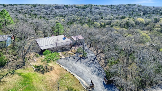 bird's eye view with a wooded view