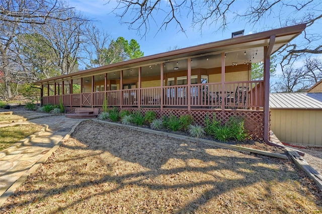 rear view of property with a porch