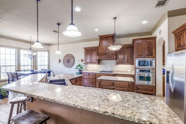 1211 Meredith Creek Ln, Fort Worth, TX 76179 - kitchen featuring a sink, tasteful backsplash, a breakfast bar, stainless steel appliances, and visible vents