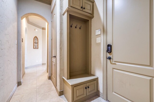 1211 Meredith Creek Ln, Fort Worth, TX 76179 - mudroom with baseboards, arched walkways, and light tile patterned floors