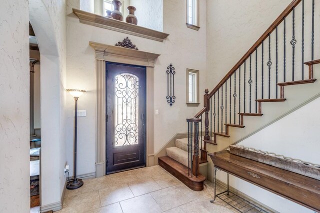1211 Meredith Creek Ln, Fort Worth, TX 76179 - foyer with tile patterned flooring, plenty of natural light, arched walkways, and stairs