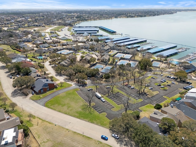 drone / aerial view with a water view and a residential view