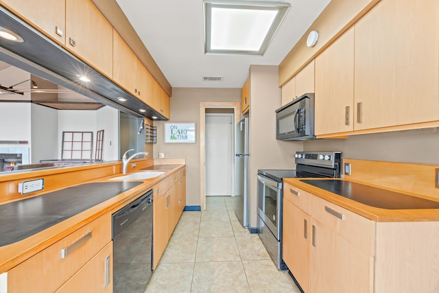 kitchen featuring a sink, visible vents, black appliances, and light brown cabinets