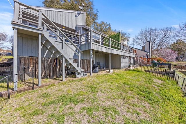 back of property with a yard, stairs, a deck, and fence