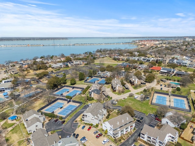 drone / aerial view with a residential view and a water view