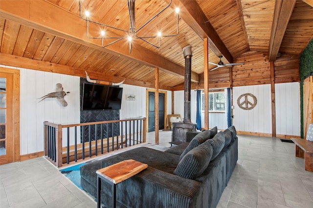 104 Henderson Harbor Cir, Payne Springs, TX 75156 - living room with a wood stove, wooden walls, wooden ceiling, and baseboards