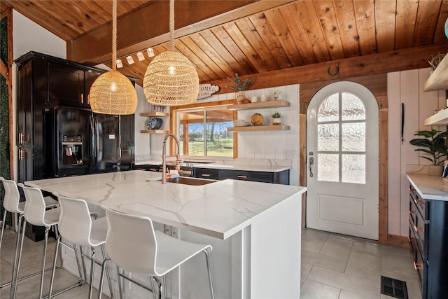 104 Henderson Harbor Cir, Payne Springs, TX 75156 - kitchen with open shelves, a sink, wooden ceiling with exposed beams, black fridge with ice dispenser, and arched walkways