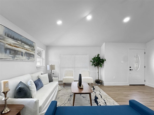 living area featuring recessed lighting, baseboards, and light wood-type flooring