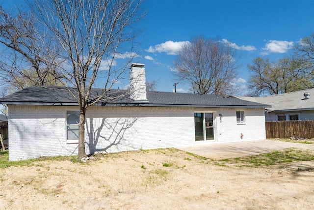 1505 W Collin, Corsicana, TX 75110 - rear view of house with a patio, fence, brick siding, and a chimney