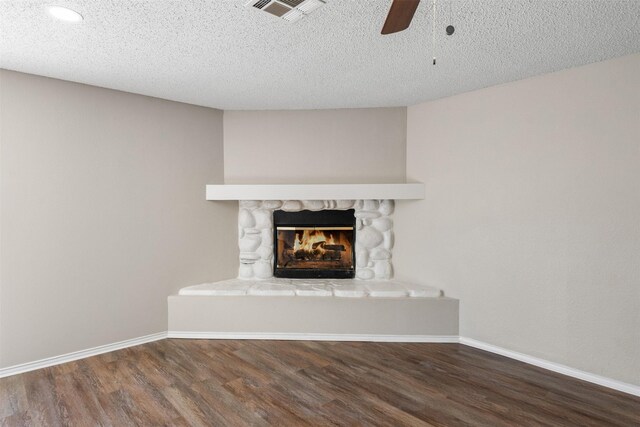 1505 W Collin, Corsicana, TX 75110 - detailed view of wood finished floors, ceiling fan, baseboards, a fireplace, and a textured ceiling