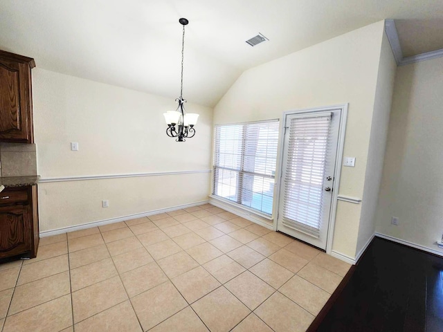 unfurnished dining area featuring light tile patterned flooring, baseboards, visible vents, a notable chandelier, and lofted ceiling
