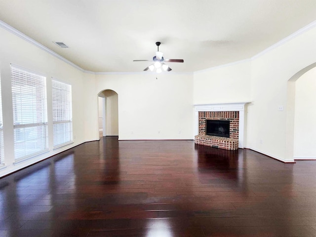 unfurnished living room featuring a fireplace, crown molding, a ceiling fan, and hardwood / wood-style flooring