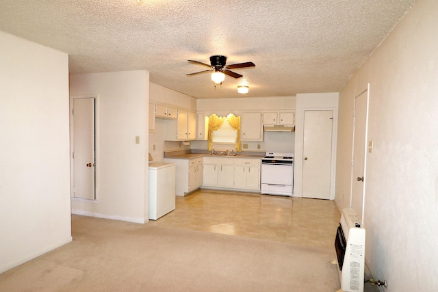 kitchen featuring washer / clothes dryer, a sink, under cabinet range hood, white electric range, and a ceiling fan