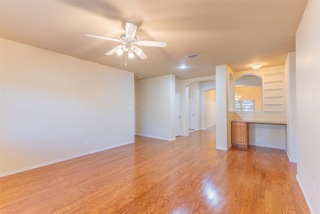 1032 Bending Oak Dr, Cedar Hill, TX 75104 - unfurnished living room with arched walkways, light wood-style floors, ceiling fan, and baseboards