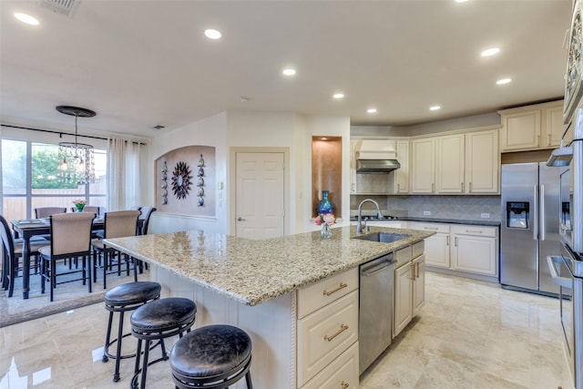 12252 Skipper Dr, Frisco, TX 75035 - kitchen with stainless steel appliances, a sink, decorative backsplash, a chandelier, and light stone countertops
