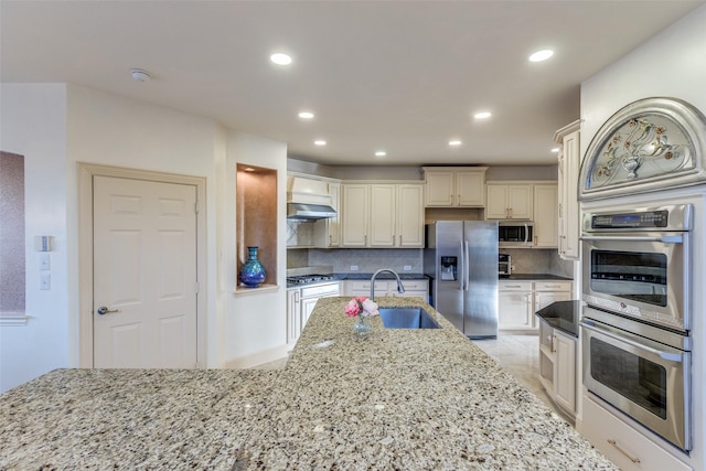 12252 Skipper Dr, Frisco, TX 75035 - kitchen with stainless steel appliances, a sink, decorative backsplash, recessed lighting, and light stone counters