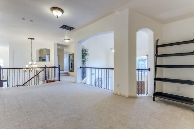 12252 Skipper Dr, Frisco, TX 75035 - unfurnished room featuring a chandelier, carpet flooring, baseboards, and arched walkways