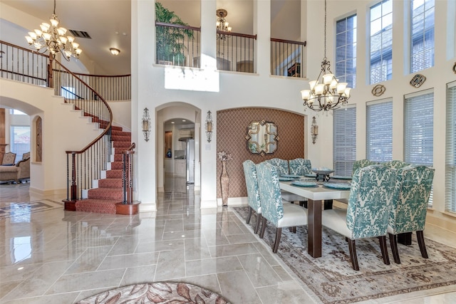 12252 Skipper Dr, Frisco, TX 75035 - dining area with a chandelier, arched walkways, a towering ceiling, and marble tiled floors