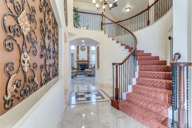 12252 Skipper Dr, Frisco, TX 75035 - foyer entrance with arched walkways, marble tiled floors, a chandelier, stairs, and baseboards