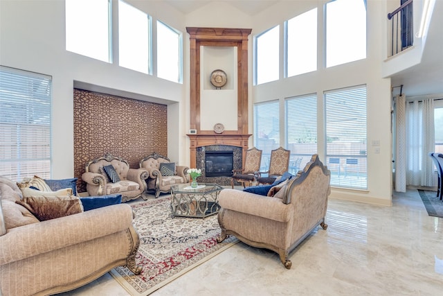 12252 Skipper Dr, Frisco, TX 75035 - living room with a high ceiling, a premium fireplace, light marble finish flooring, and baseboards
