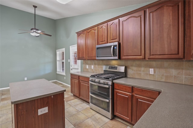 11279 Snyder Dr, Frisco, TX 75035 - kitchen with appliances with stainless steel finishes, decorative backsplash, ceiling fan, a kitchen island, and high vaulted ceiling