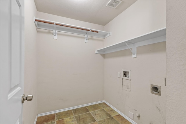 11279 Snyder Dr, Frisco, TX 75035 - clothes washing area with hookup for a gas dryer, hookup for a washing machine, stone finish flooring, baseboards, and electric dryer hookup