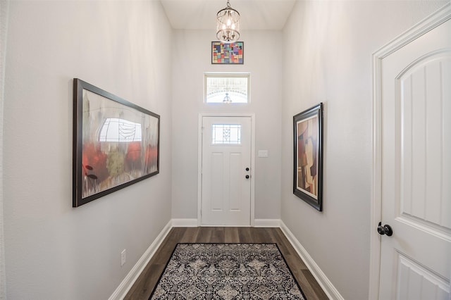 2655 Kathleen Ave, Dallas, TX 75216 - doorway to outside with dark wood-style floors, baseboards, and a chandelier