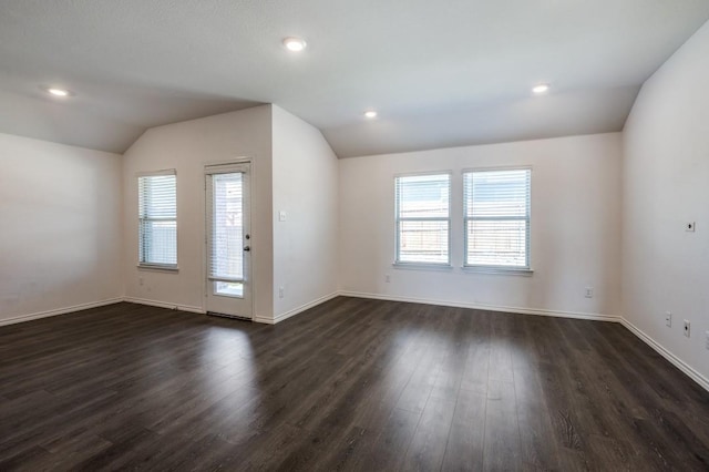 interior space with recessed lighting, plenty of natural light, dark wood finished floors, and vaulted ceiling