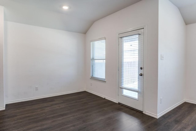 doorway with vaulted ceiling, plenty of natural light, and dark wood-style flooring
