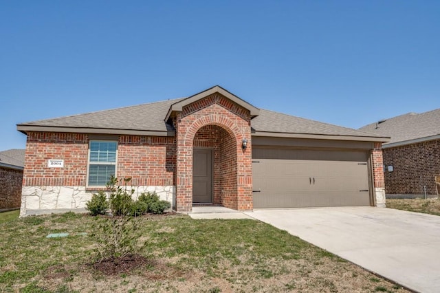 ranch-style home with brick siding, a front lawn, concrete driveway, roof with shingles, and a garage