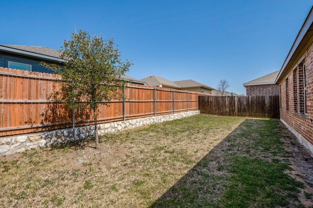 view of yard with a fenced backyard