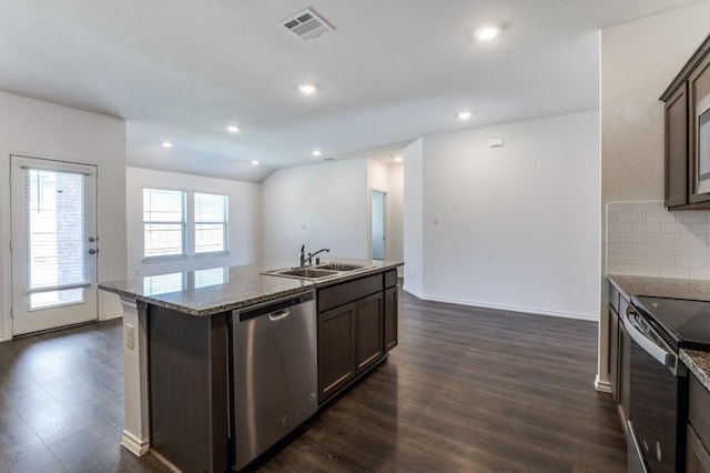 kitchen featuring visible vents, dark wood-type flooring, a sink, appliances with stainless steel finishes, and decorative backsplash