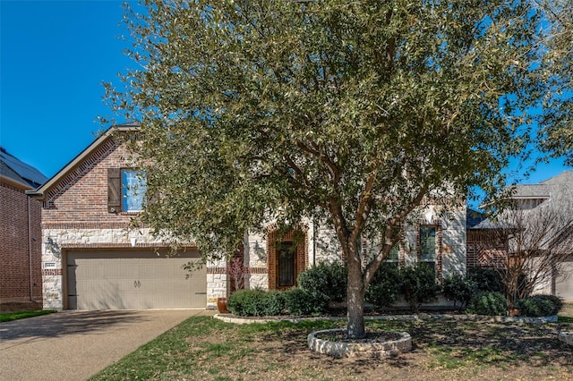 9848 Robinwoods Dr, Frisco, TX 75035 - view of property hidden behind natural elements featuring a garage, concrete driveway, brick siding, and stone siding