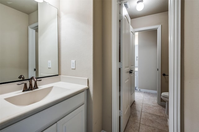 9848 Robinwoods Dr, Frisco, TX 75035 - bathroom featuring toilet, vanity, and tile patterned floors
